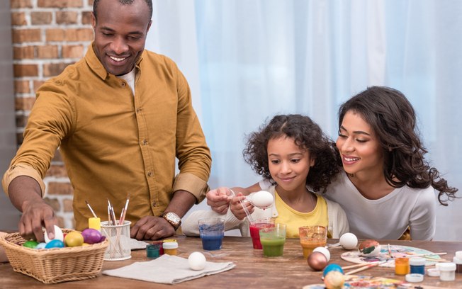 Family painting eggs for Easter