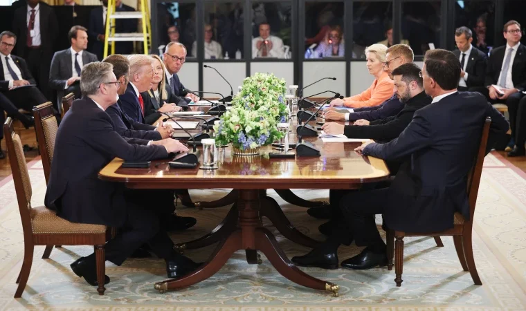 A wide-shot photo of the White House meeting table with Trump, Zelenskyy, and European leaders