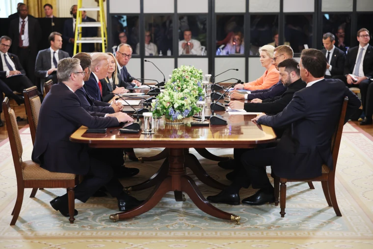 A wide-shot photo of the White House meeting table with Trump, Zelenskyy, and European leaders