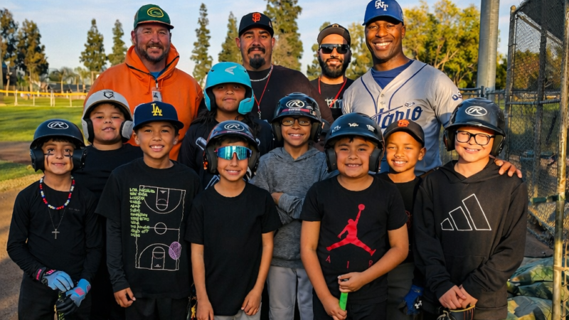 Ontario youth Little League players and coaches gathered on a baseball field during golden hour, representing Ontario Mountain View Little League AAA sponsored by the D’Andre D. Lampkin Foundation.