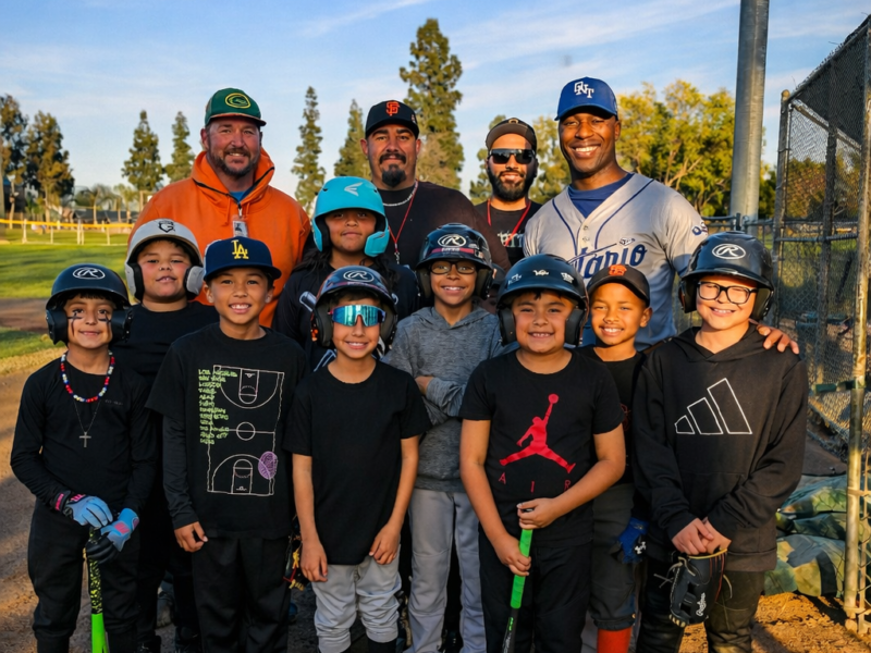 Ontario youth Little League players and coaches gathered on a baseball field during golden hour, representing Ontario Mountain View Little League AAA sponsored by the D’Andre D. Lampkin Foundation.