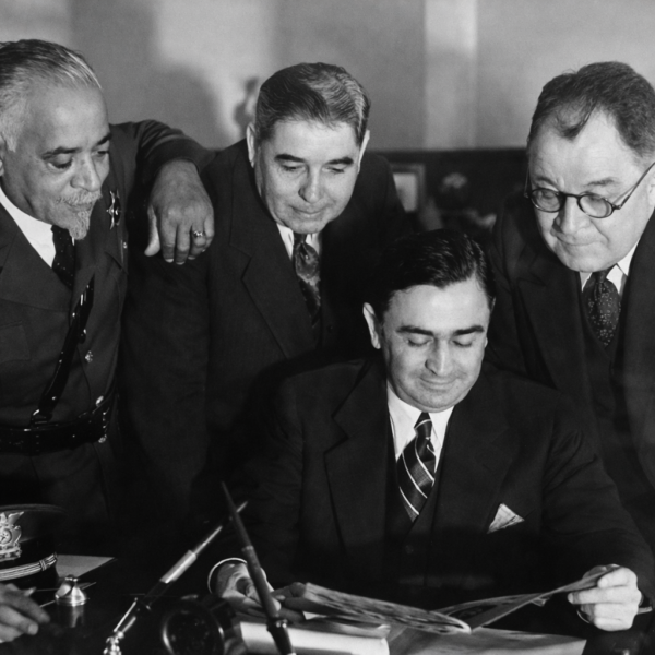Deputy Julius Boyd Loving with Los Angeles County Sheriff Eugene Biscailuz reviewing documents, early 20th century