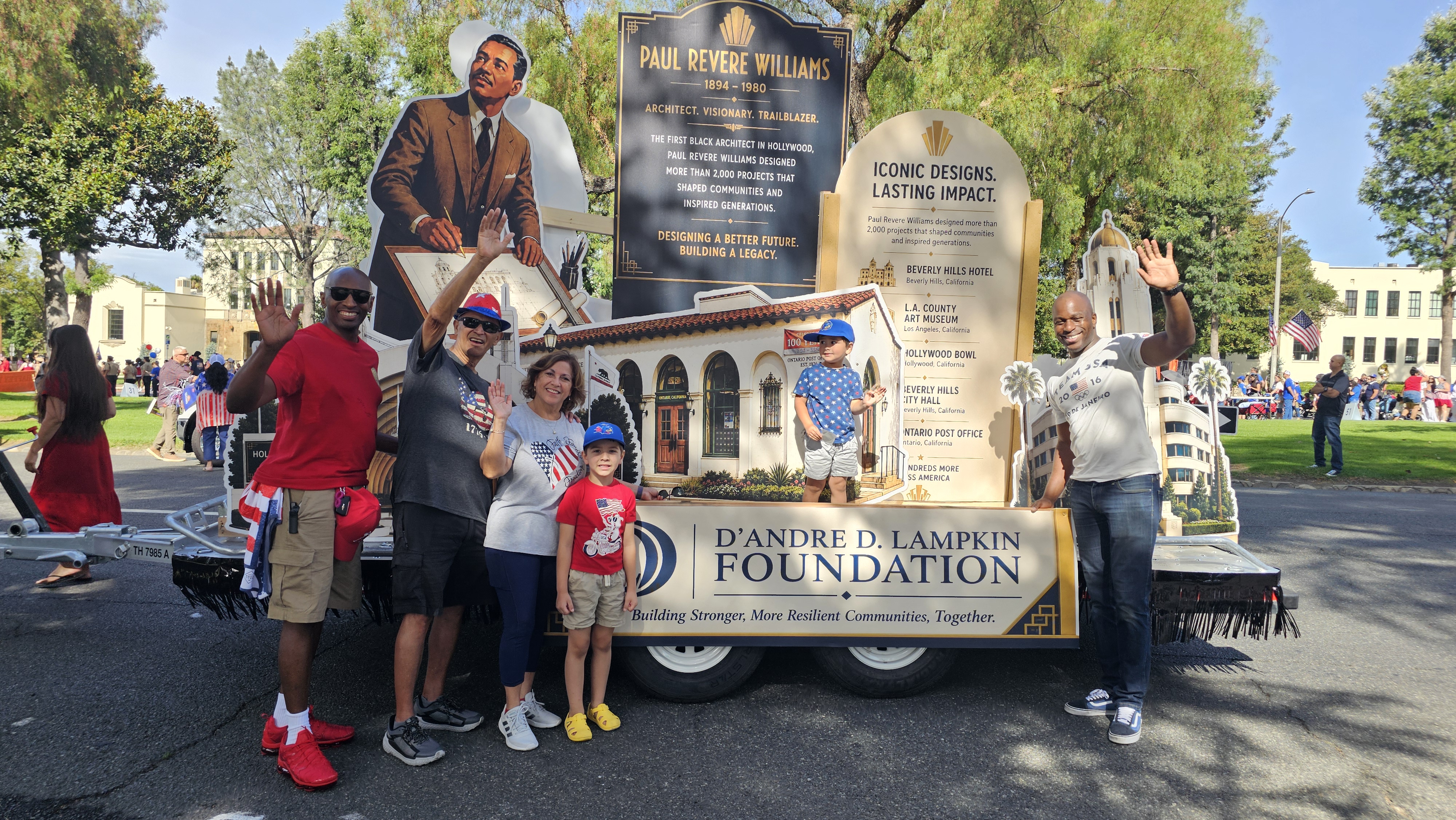 Community members and families gather around the D'Andre D. Lampkin Foundation's award-winning Paul Revere Williams parade float during the 2026 City of Ontario Independence Day Parade after receiving the Chaffey Heritage Award.